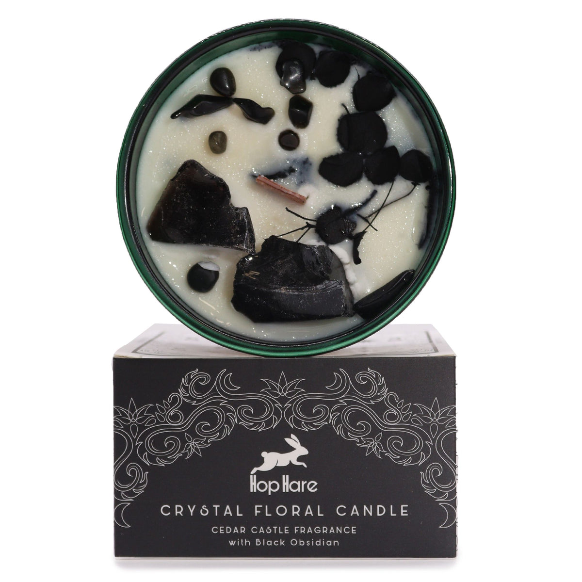 Bougie blanche ornée d'obsidienne noire et de fleurs séchées noires, posée sur sa boîte