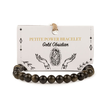 Bracelet en perles d'obsidienne dorée posé devant sa carte de présentation illustrée