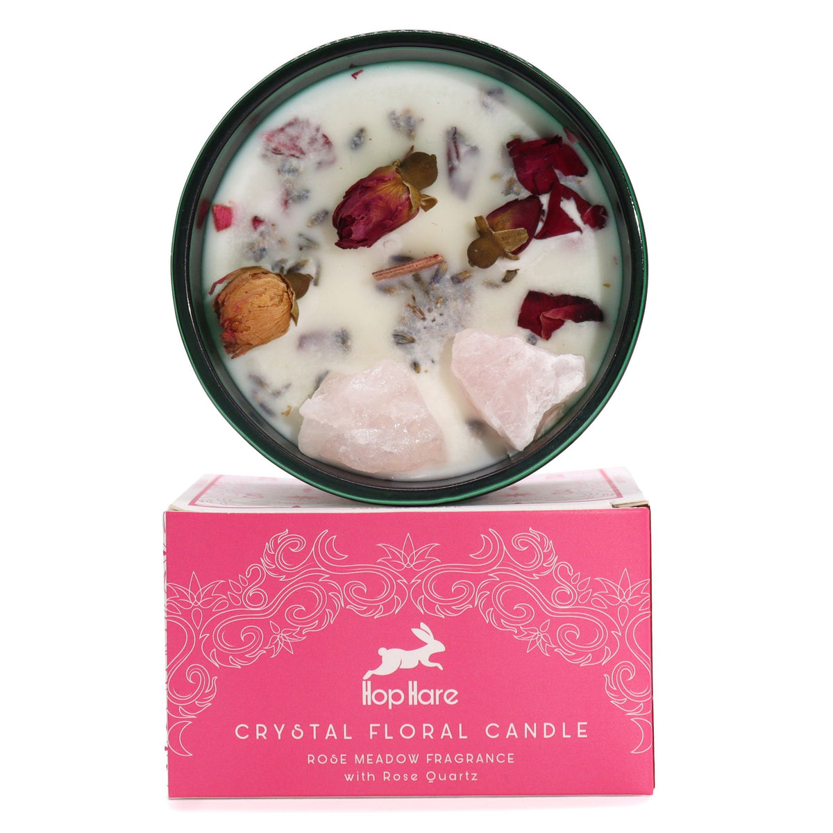 Bougie blanche en pot de verre vert avec quartz rose brut et roses séchées