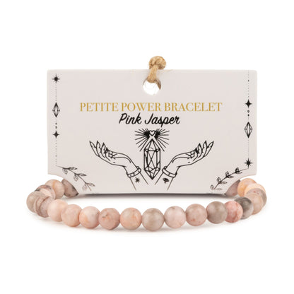 Bracelet de perles en jaspe rose aux nuances crème et grises sur carte illustrée